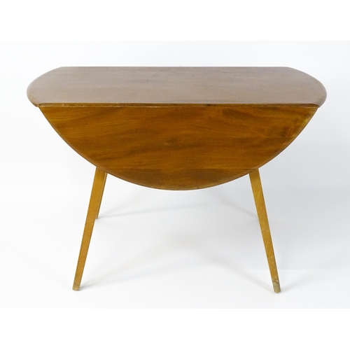 1631 - Vintage / Retro: An elm Ercol drop flap table with two demi lune leaves raised on four tapering legs... 