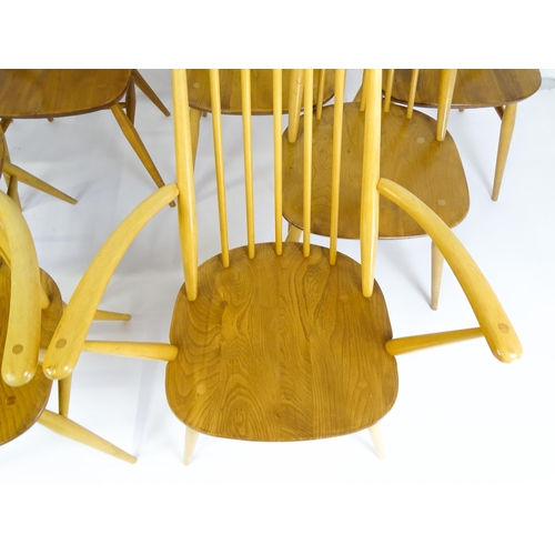 1632 - Vintage / Retro: A set of eight Ercol 'Goldsmith' Windsor dining chairs, with comb backs and shaped ... 