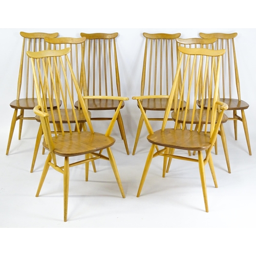 1632 - Vintage / Retro: A set of eight Ercol 'Goldsmith' Windsor dining chairs, with comb backs and shaped ... 