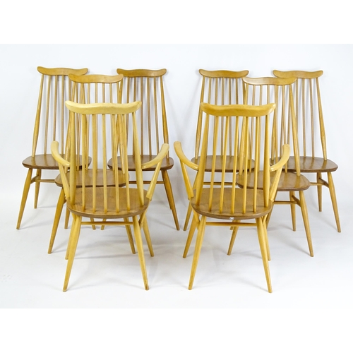 1632 - Vintage / Retro: A set of eight Ercol 'Goldsmith' Windsor dining chairs, with comb backs and shaped ... 