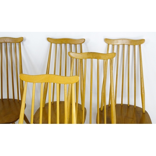 1632 - Vintage / Retro: A set of eight Ercol 'Goldsmith' Windsor dining chairs, with comb backs and shaped ... 