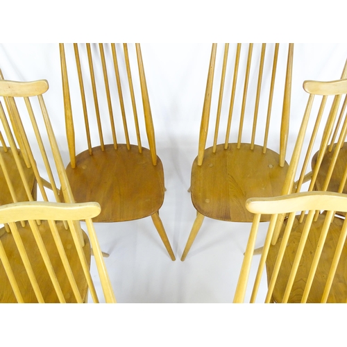 1632 - Vintage / Retro: A set of eight Ercol 'Goldsmith' Windsor dining chairs, with comb backs and shaped ... 