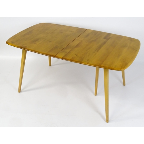 1633 - Vintage / Retro: An elm Ercol extending dining table raised on five tapering splayed legs. 60