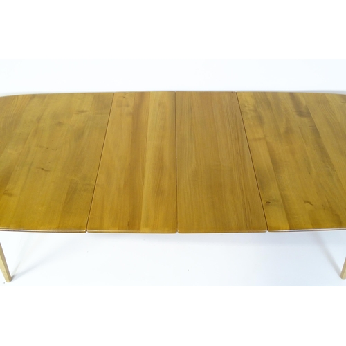 1633 - Vintage / Retro: An elm Ercol extending dining table raised on five tapering splayed legs. 60