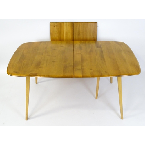 1633 - Vintage / Retro: An elm Ercol extending dining table raised on five tapering splayed legs. 60