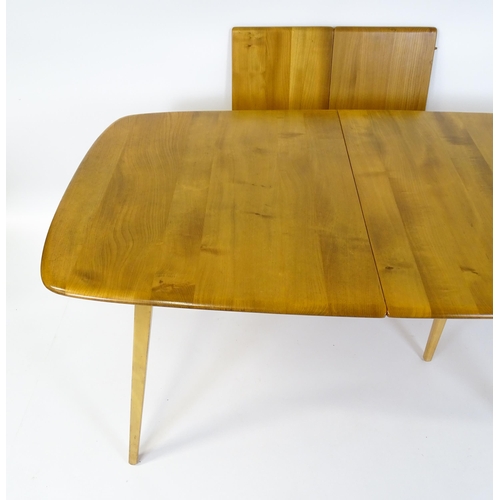 1633 - Vintage / Retro: An elm Ercol extending dining table raised on five tapering splayed legs. 60