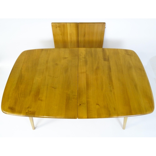 1633 - Vintage / Retro: An elm Ercol extending dining table raised on five tapering splayed legs. 60