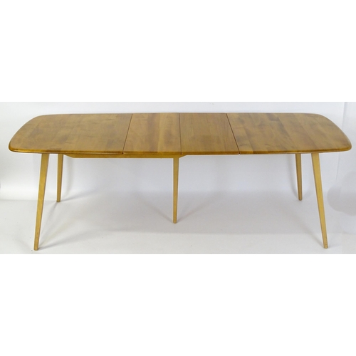 1633 - Vintage / Retro: An elm Ercol extending dining table raised on five tapering splayed legs. 60