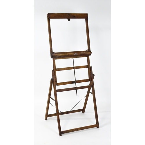 1639 - An early 20thC oak Clifford Milburn adjustable easel. Bearing plaque. 'Clifford Milburn, Commercial ... 