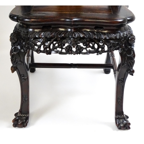 1452 - A pair of late 19thC / early 20thC Chinese hardwood side chairs with intricately carved frames depic... 