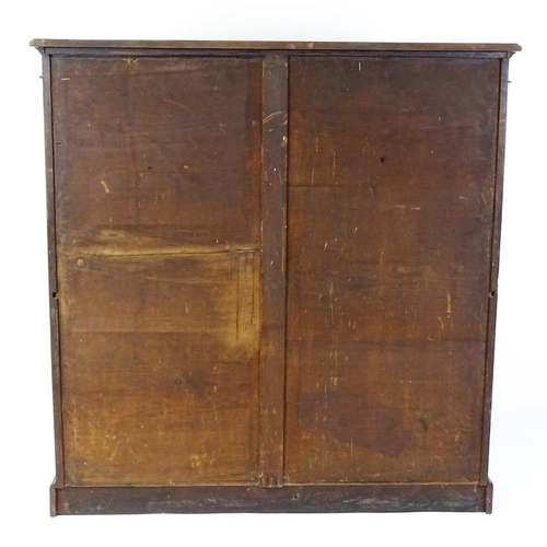 1470 - A late 19thC mahogany bookcase with a moulded cornice above four adjustable shelves. 56