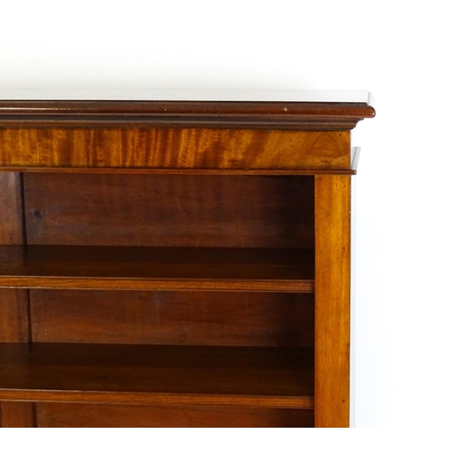 1470 - A late 19thC mahogany bookcase with a moulded cornice above four adjustable shelves. 56