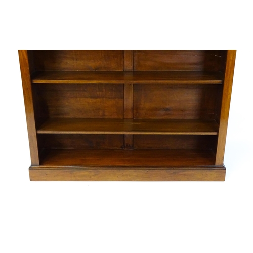 1470 - A late 19thC mahogany bookcase with a moulded cornice above four adjustable shelves. 56