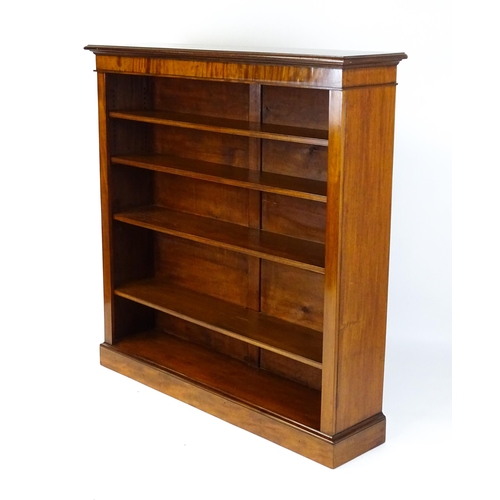 1470 - A late 19thC mahogany bookcase with a moulded cornice above four adjustable shelves. 56