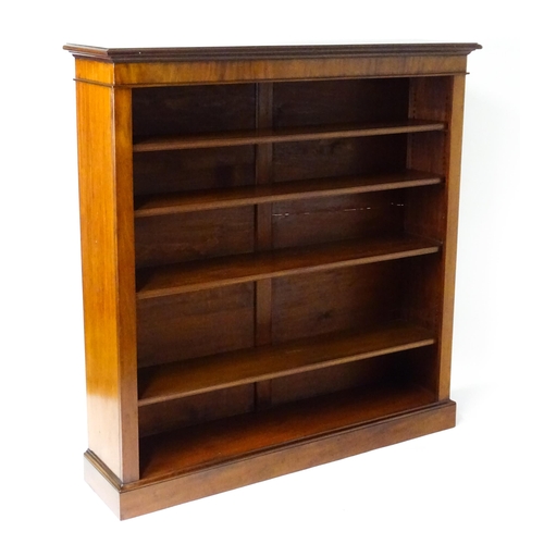 1470 - A late 19thC mahogany bookcase with a moulded cornice above four adjustable shelves. 56