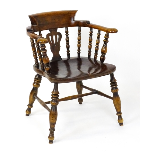 1478 - A late 19thC / early 20thC smokers bow armchair with a pierced vase shaped back splat alongside turn... 