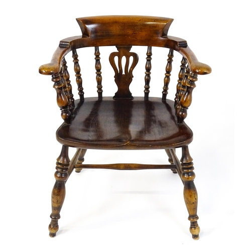 1478 - A late 19thC / early 20thC smokers bow armchair with a pierced vase shaped back splat alongside turn... 