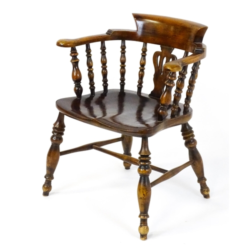 1478 - A late 19thC / early 20thC smokers bow armchair with a pierced vase shaped back splat alongside turn... 