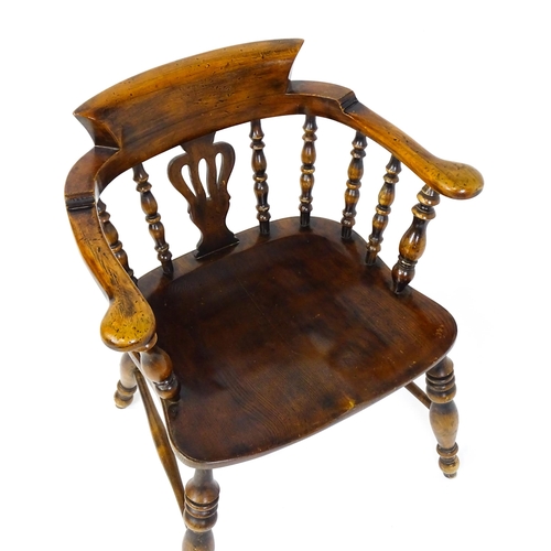 1478 - A late 19thC / early 20thC smokers bow armchair with a pierced vase shaped back splat alongside turn... 