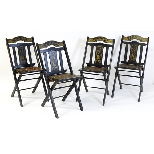 1491 - A set of four early 20thC lacquered folding chairs with chinoiserie decoration and caned seats. 16