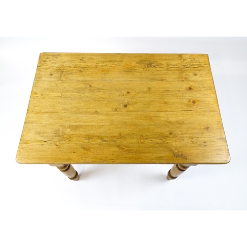 1497 - An early 20thC pine table with a single drop leaf raised on four turned tapering legs. 35