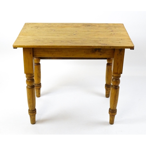 1497 - An early 20thC pine table with a single drop leaf raised on four turned tapering legs. 35