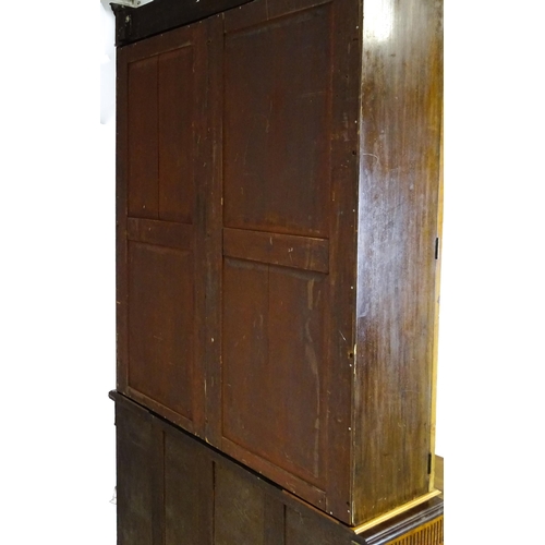 1503 - A late 19thC / early 20thC mahogany bookcase with a moulded fluted cornice above two astragal glazed... 