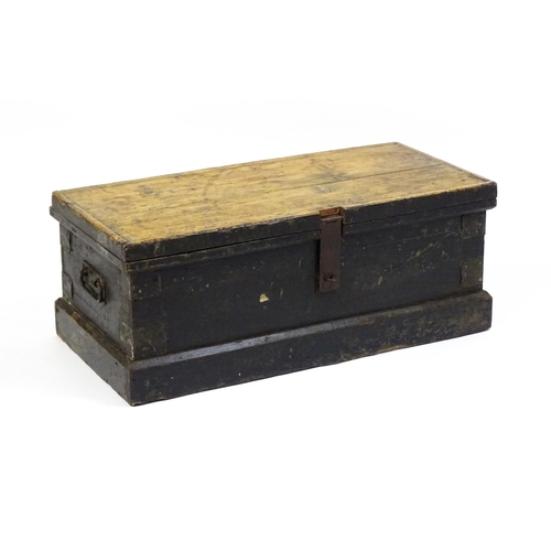 1524 - A 19thC pine trunk with a hinged lid flanked by wrought iron handles. 34