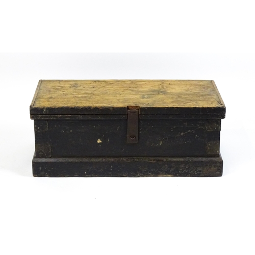 1524 - A 19thC pine trunk with a hinged lid flanked by wrought iron handles. 34