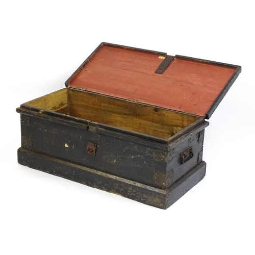 1524 - A 19thC pine trunk with a hinged lid flanked by wrought iron handles. 34