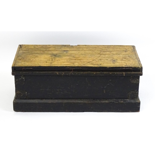 1524 - A 19thC pine trunk with a hinged lid flanked by wrought iron handles. 34