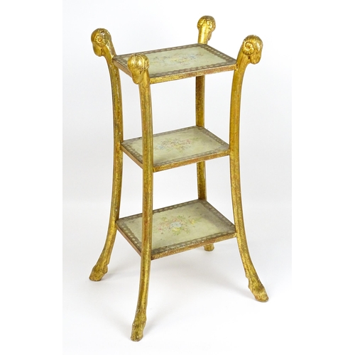 1530 - A William Kent style etagere with three tiers raised on splayed supports with rams head terminals an... 