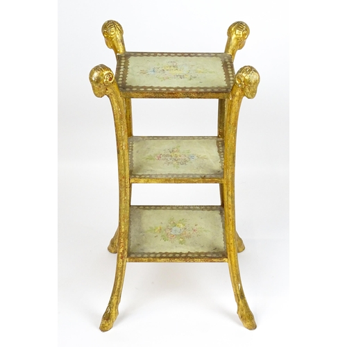 1530 - A William Kent style etagere with three tiers raised on splayed supports with rams head terminals an... 