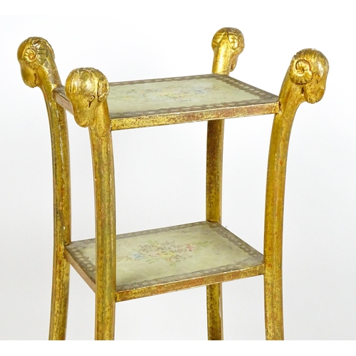 1530 - A William Kent style etagere with three tiers raised on splayed supports with rams head terminals an... 