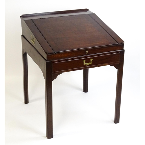 1552 - An early 19thC mahogany campaign style writing desk / clerks desk with a hinged lid and single short... 