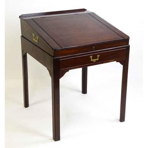 1552 - An early 19thC mahogany campaign style writing desk / clerks desk with a hinged lid and single short... 