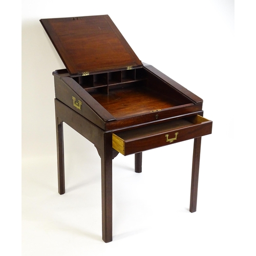 1552 - An early 19thC mahogany campaign style writing desk / clerks desk with a hinged lid and single short... 