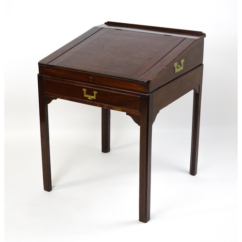 1552 - An early 19thC mahogany campaign style writing desk / clerks desk with a hinged lid and single short... 