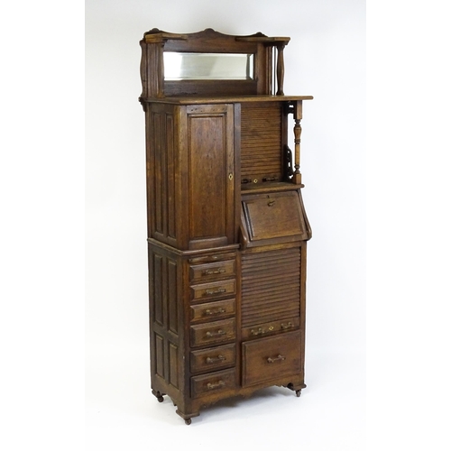 1444 - A late 19thC oak dentist cabinet in the manner of Harvard & Co. The cabinet having a mirrored top se... 