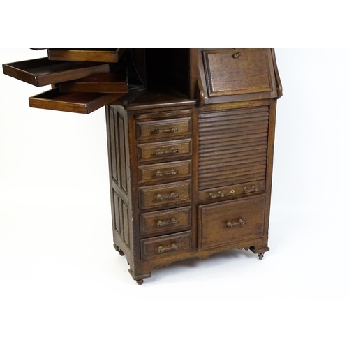 1444 - A late 19thC oak dentist cabinet in the manner of Harvard & Co. The cabinet having a mirrored top se... 