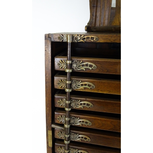 1444 - A late 19thC oak dentist cabinet in the manner of Harvard & Co. The cabinet having a mirrored top se... 