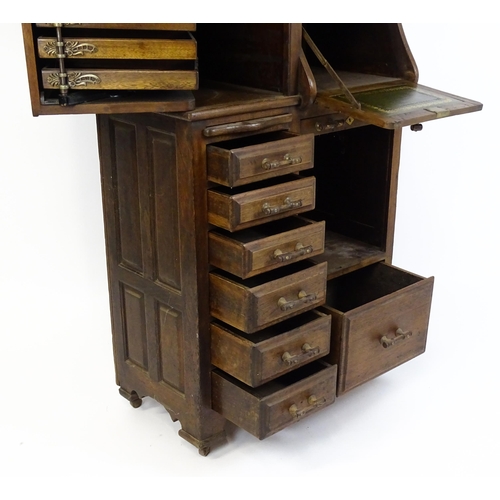 1444 - A late 19thC oak dentist cabinet in the manner of Harvard & Co. The cabinet having a mirrored top se... 