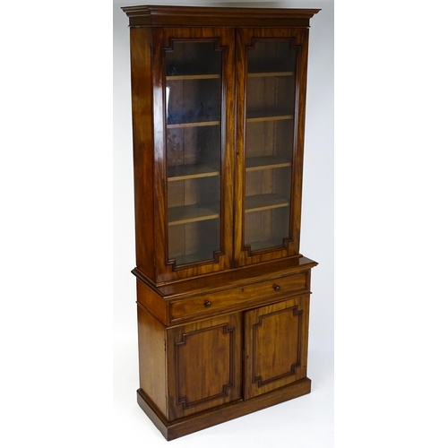 1445 - A Victorian mahogany bookcase with a moulded cornice above a glazed top and four adjustable shelves,... 