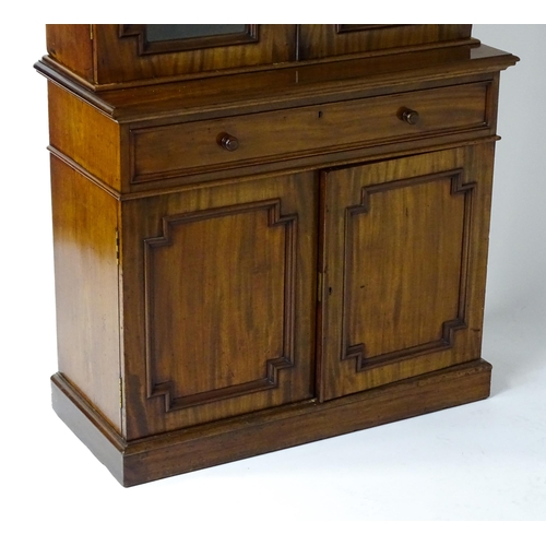 1445 - A Victorian mahogany bookcase with a moulded cornice above a glazed top and four adjustable shelves,... 