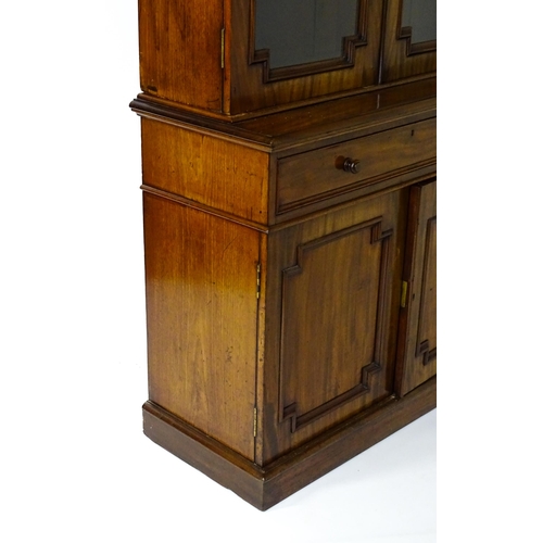 1445 - A Victorian mahogany bookcase with a moulded cornice above a glazed top and four adjustable shelves,... 