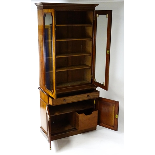 1445 - A Victorian mahogany bookcase with a moulded cornice above a glazed top and four adjustable shelves,... 