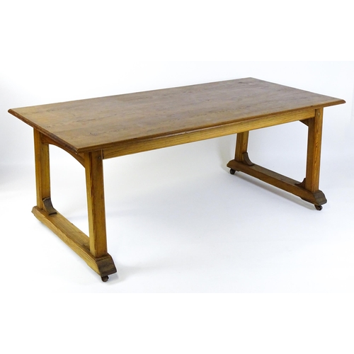 1453 - An early 20thC Heals style pine dining table with a rectangular moulded top above four straight legs... 