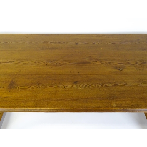 1453 - An early 20thC Heals style pine dining table with a rectangular moulded top above four straight legs... 