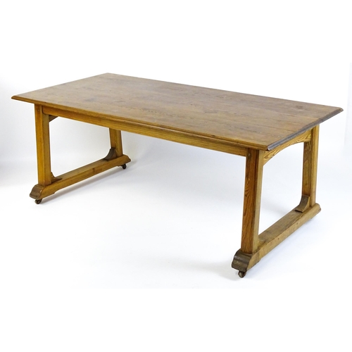 1453 - An early 20thC Heals style pine dining table with a rectangular moulded top above four straight legs... 