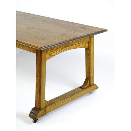 1453 - An early 20thC Heals style pine dining table with a rectangular moulded top above four straight legs... 